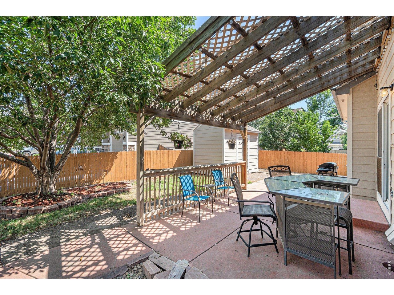 11226 Dover Street Firestone, CO 80504 - Photo 22 of 27 a view of a patio with a table chair and a barbeque