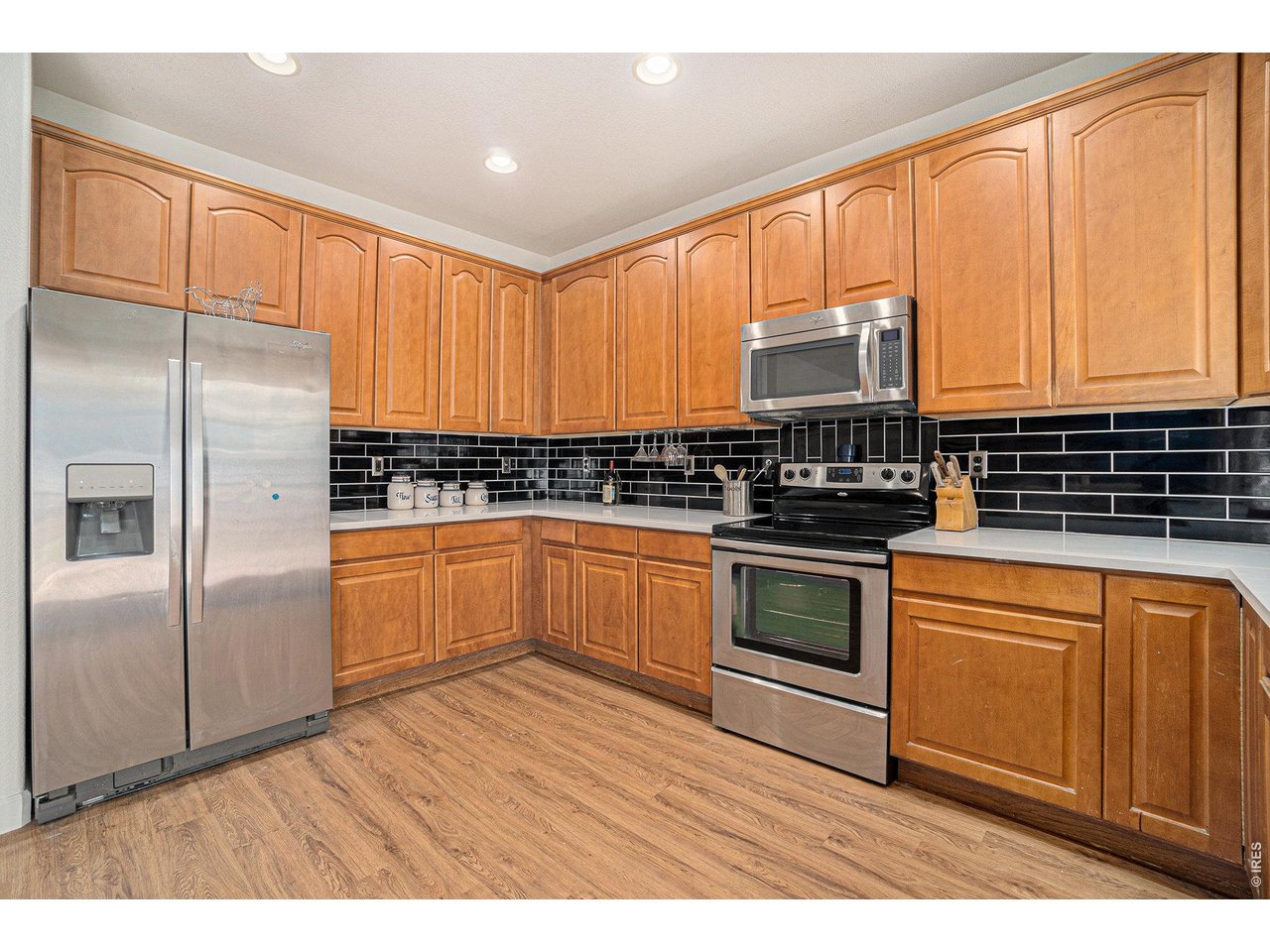 11226 Dover Street Firestone, CO 80504 - Photo 7 of 27 a kitchen with stainless steel appliances granite countertop a stove a sink dishwasher and a refrigerator