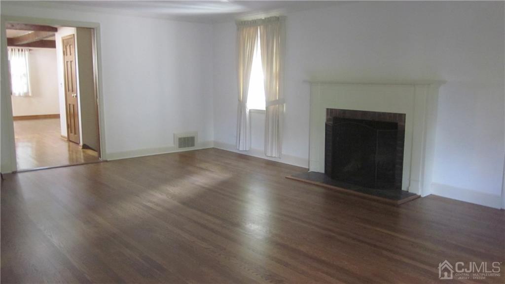 3 Southfield Road Edison, NJ 08820 - Photo 6 of 20 an empty room with wooden floor and windows