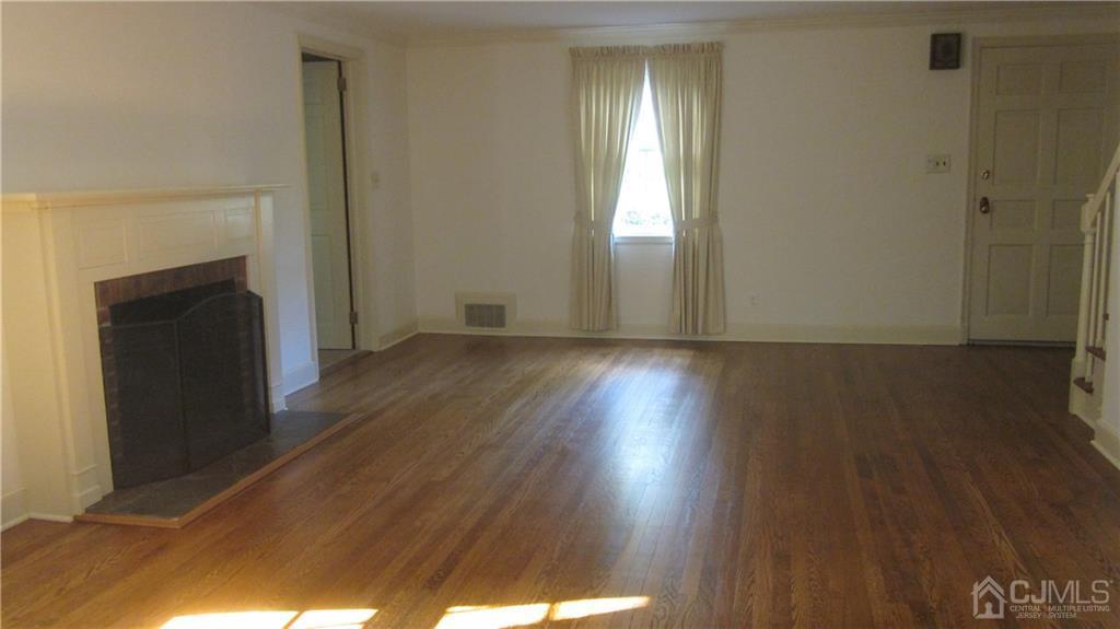3 Southfield Road Edison, NJ 08820 - Photo 7 of 20 an empty room with wooden floor and windows