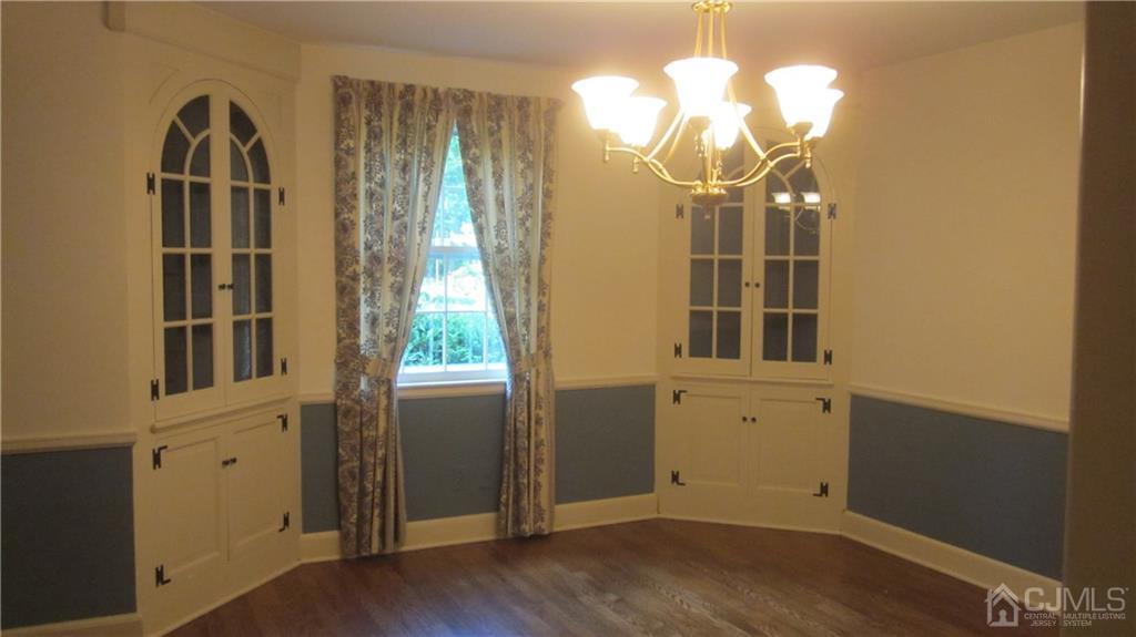 3 Southfield Road Edison, NJ 08820 - Photo 9 of 20 an empty room with wooden floor fan and windows