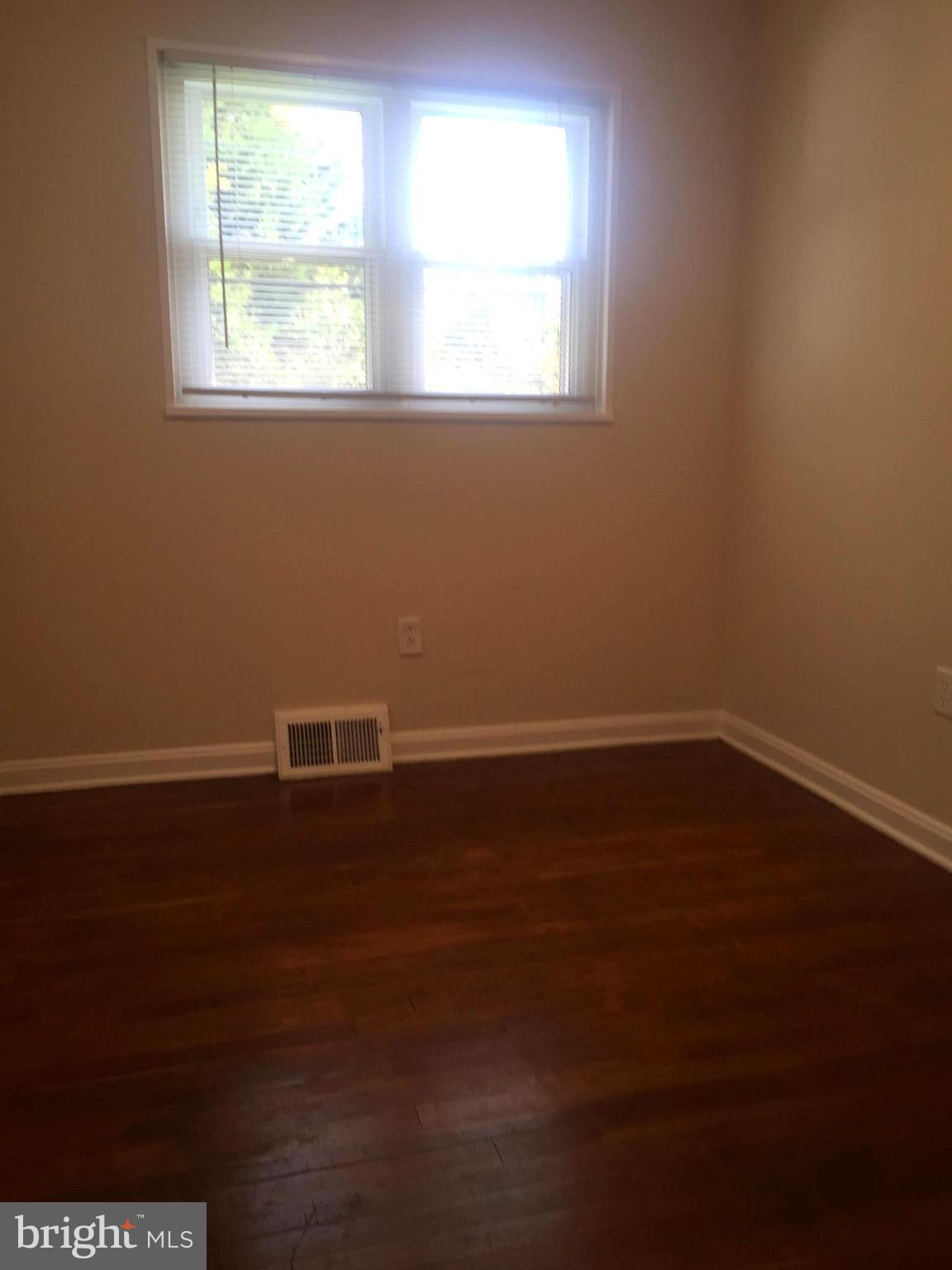 1605 West 7th Street Frederick, MD 21702 - Photo 11 of 19 an empty room with wooden floor and windows