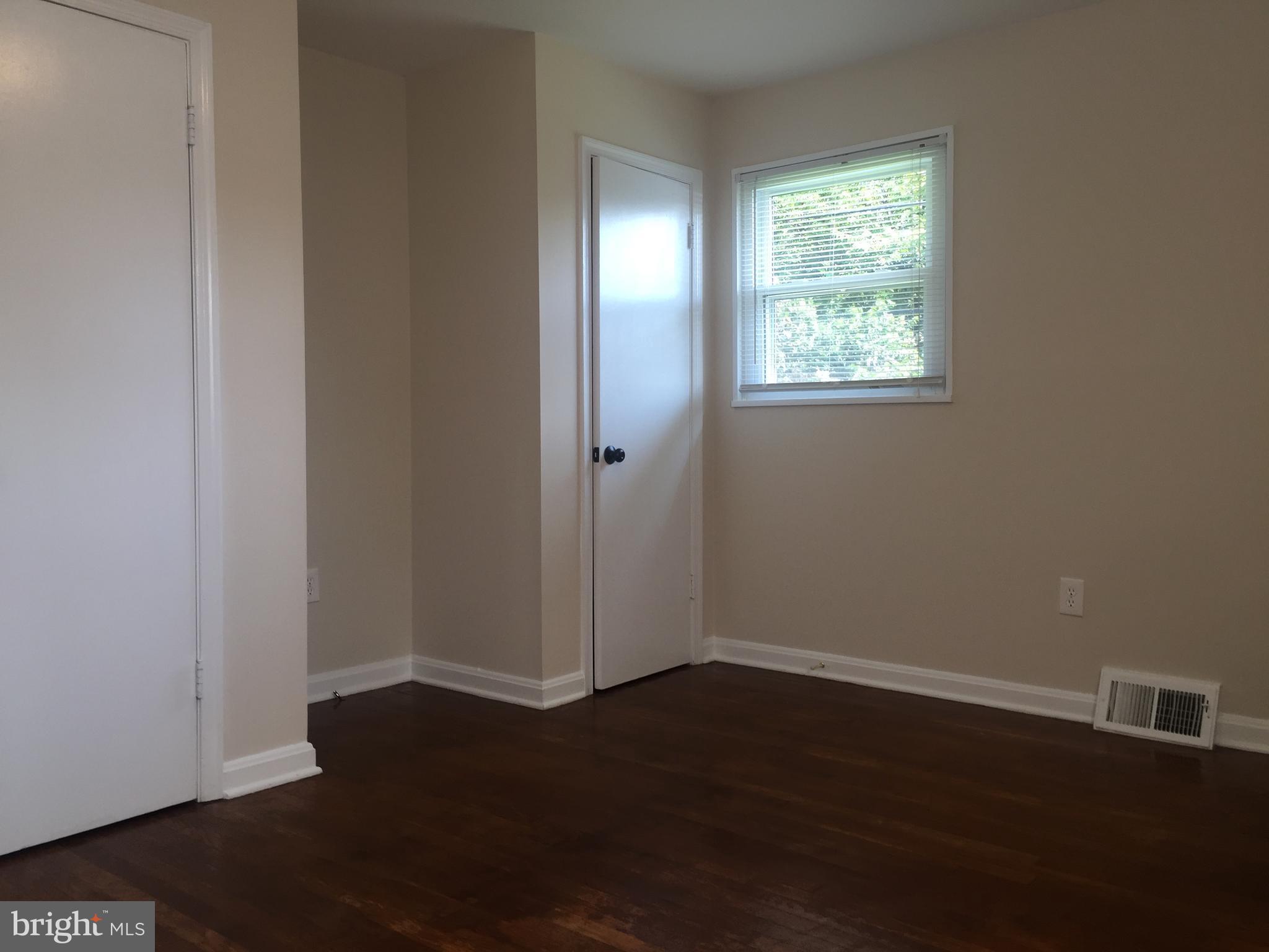 1605 West 7th Street Frederick, MD 21702 - Photo 13 of 19 an empty room with wooden floor and windows