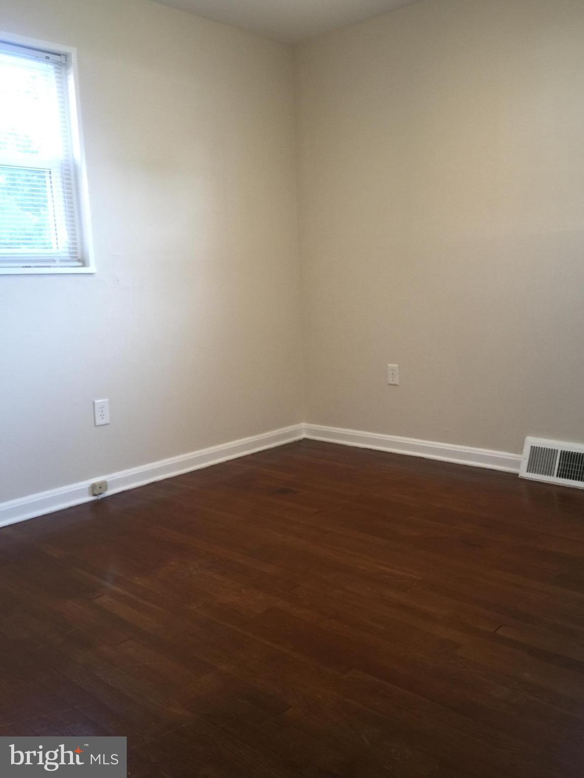 1605 West 7th Street Frederick, MD 21702 - Photo 10 of 19 a view of an empty room with wooden floor and windows