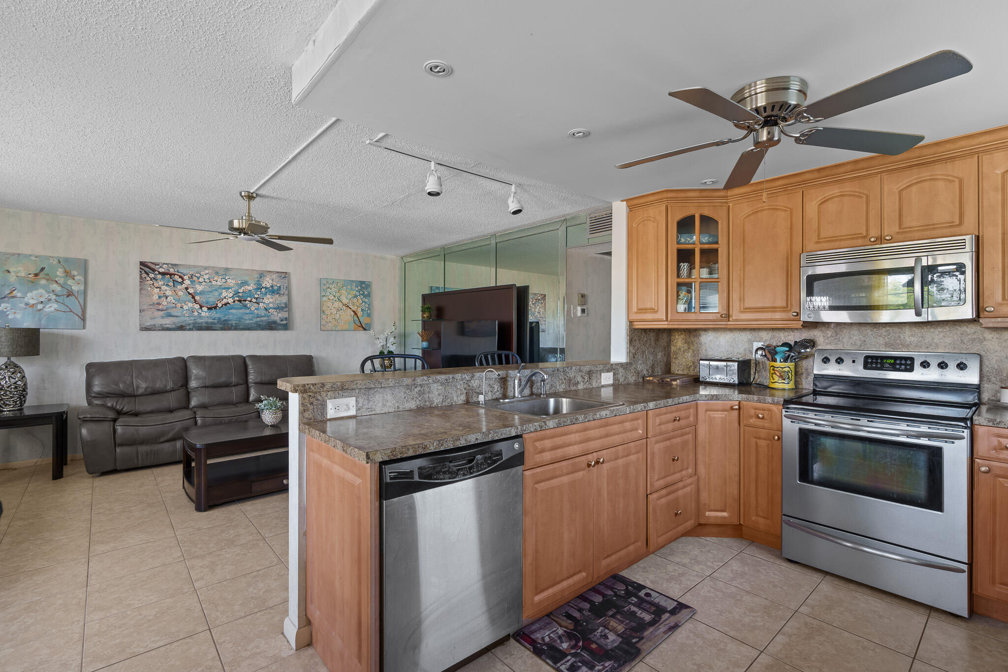 a kitchen with stainless steel appliances granite countertop a stove cabinets and a sink