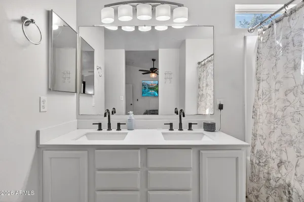 a bathroom with a double vanity sink mirror and double