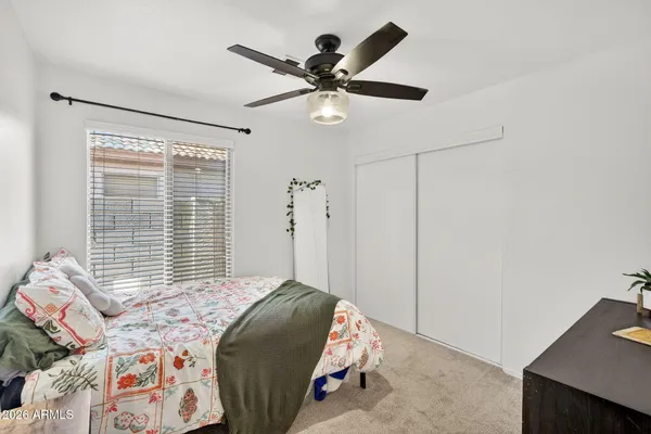 a bedroom with a bed and a window
