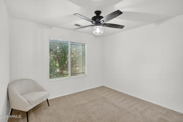 a view of a livingroom with a ceiling fan and a window