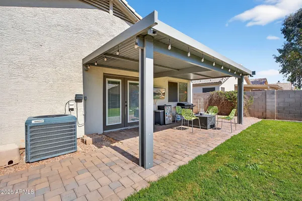 a view of a house with backyard porch and sitting area