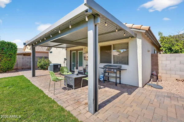a view of a patio with a table and chairs and potted plants