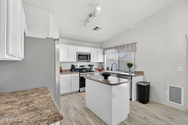 a kitchen with a stove a sink and a refrigerator