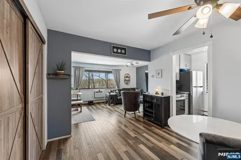 a large kitchen with a table chairs refrigerator and a stove