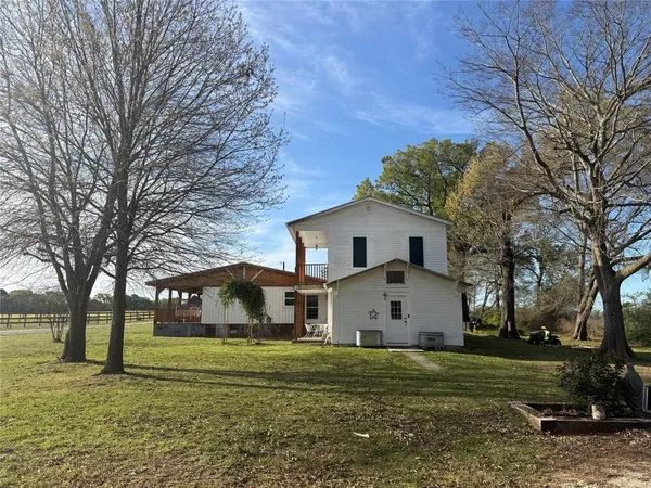 a front view of house with yard and trees