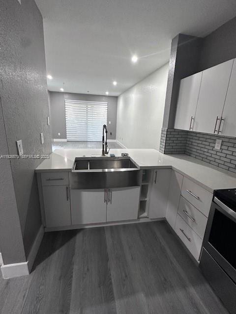 7100 Northwest 177th Street, Unit 100 Hialeah, FL 33015 - Photo 1 of 13 a kitchen with a sink appliances and cabinets
