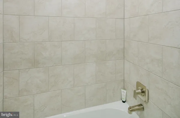 a bathroom with a sink a vanity and a bathtub