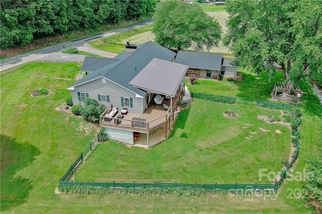 an aerial view of a house with swimming pool garden and patio