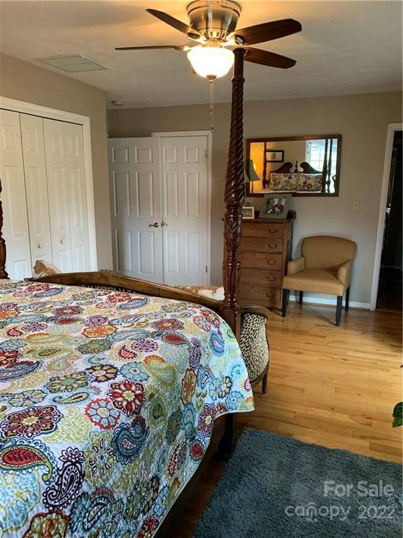 1115 Gouges Branch Road Leicester, NC 28748 - Photo 20 of 48 a bedroom with a bed a dresser and potted plant