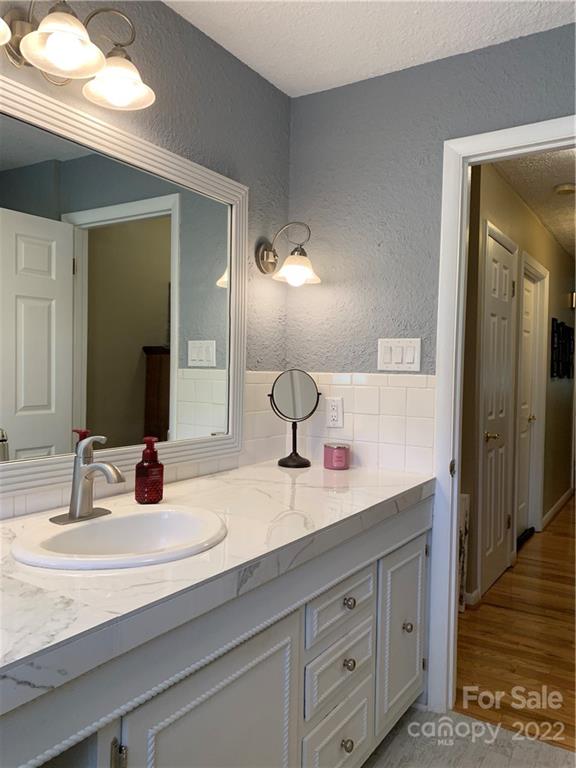 1115 Gouges Branch Road Leicester, NC 28748 - Photo 25 of 48 a bathroom with a double vanity sink and a mirror