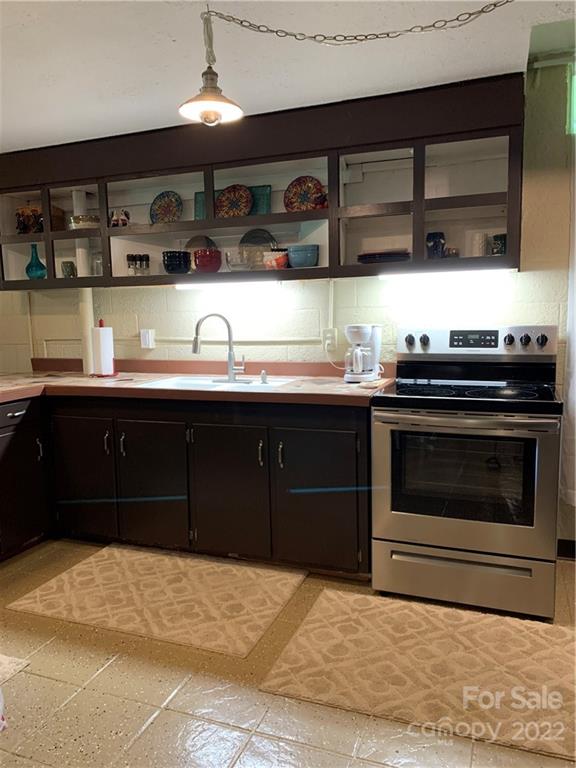 1115 Gouges Branch Road Leicester, NC 28748 - Photo 28 of 48 a kitchen with a sink and stove