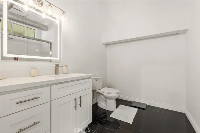 a view of a brick house with large windows and a tree