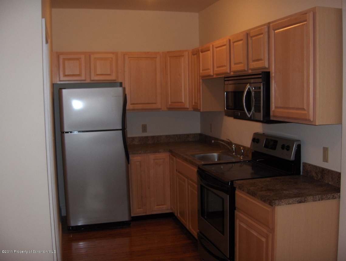 329 Penn Avenue Scranton, PA 18503 - Photo 3 of 5 a kitchen with a refrigerator stove and microwave