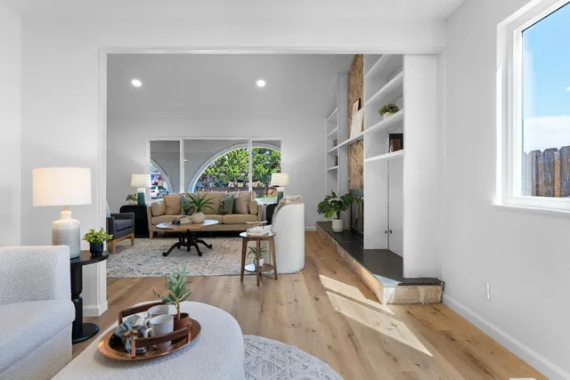 a living room with furniture and wooden floor