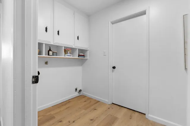 a bathroom with a toilet sink vanity and mirror