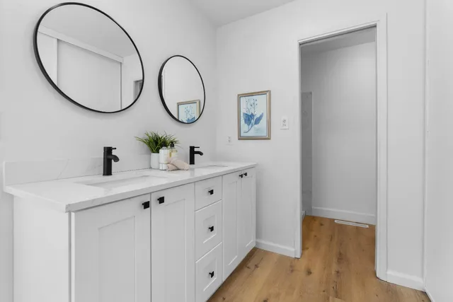 a white toilet sitting next to a white wall