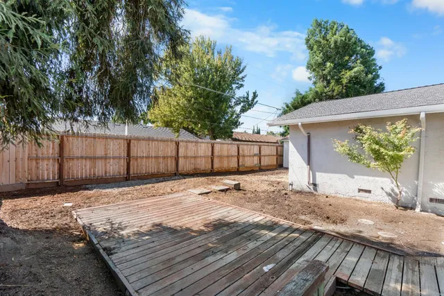 an aerial view of a house with garden space and trees