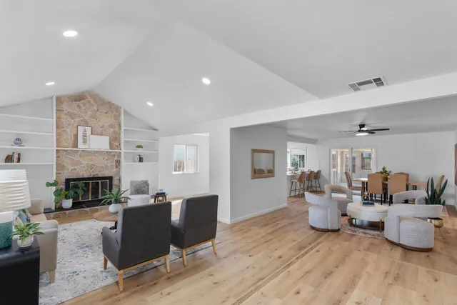 a living room with furniture a fireplace and a potted plant