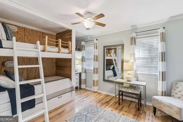 a bedroom with a bed and a desk