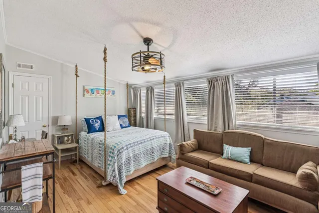 a bedroom with a bed couch and window