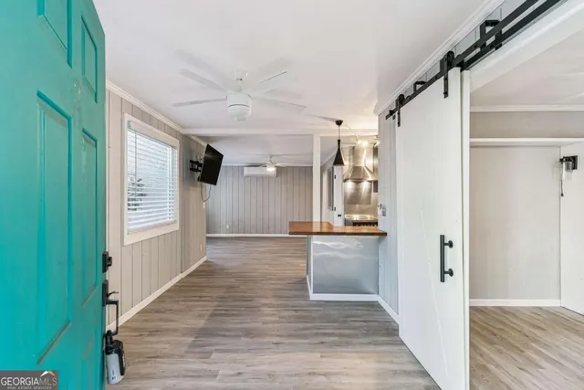 a view of a hallway view with wooden floor and staircase