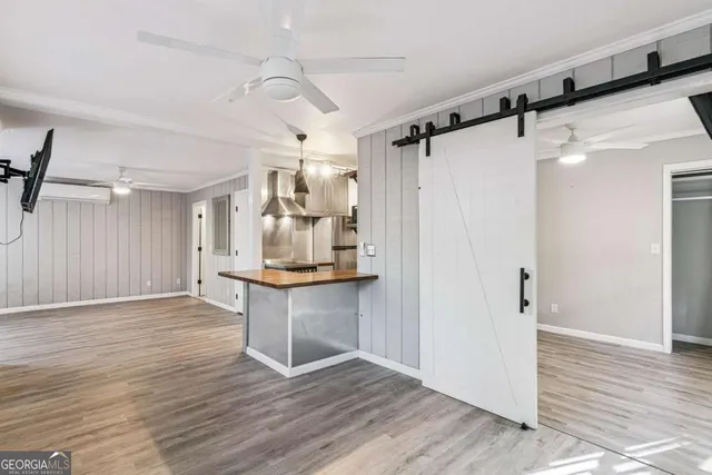 a view of a kitchen with a sink and wooden floor