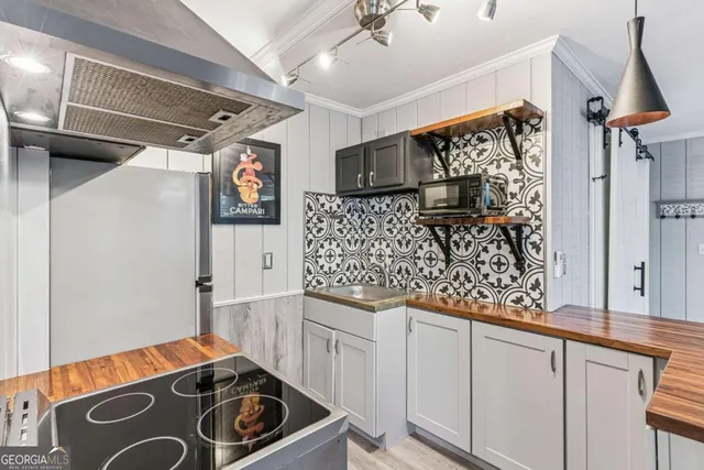 a kitchen with stainless steel appliances granite countertop a sink stove and cabinets