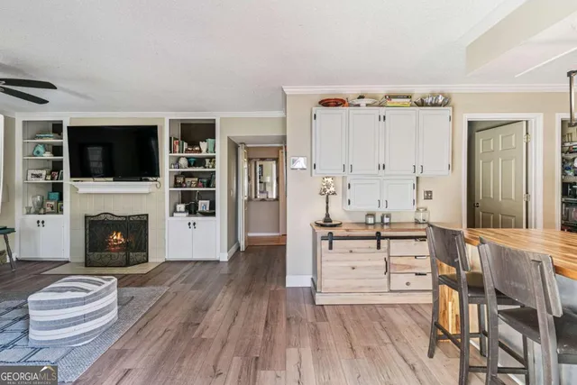 a living room with furniture fireplace and flat screen tv