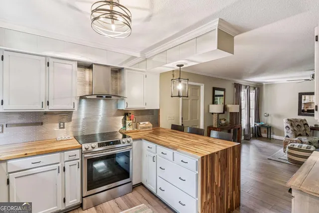 a kitchen with granite countertop a stove and a sink