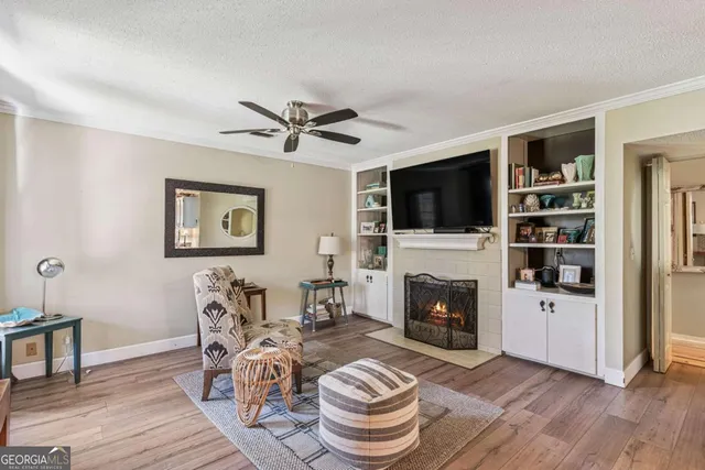 a living room with furniture a fireplace and a flat screen tv