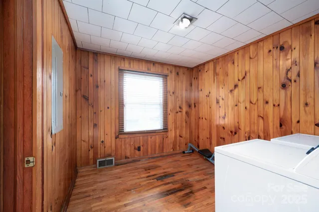 a view of a room with a wooden floor and next to a window