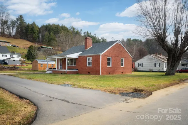 a front view of house with yard and trees