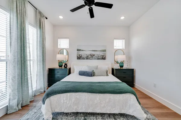 a bedroom with a large bed and a chandelier