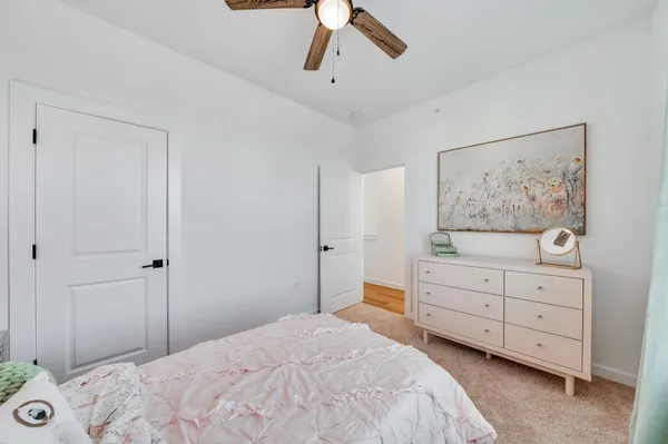 a bedroom with a bed and a painting on the wall