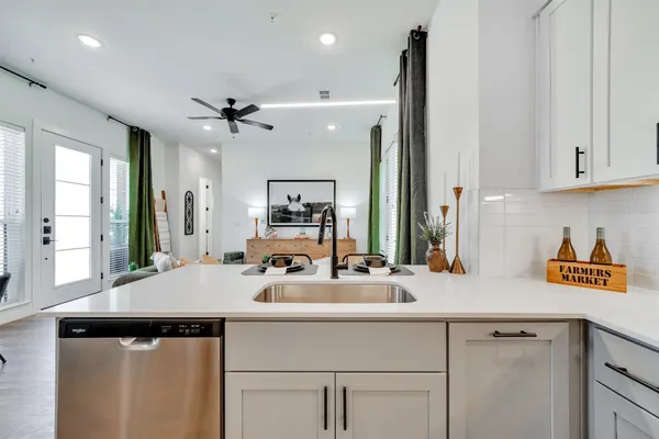 a kitchen with a sink cabinets and window