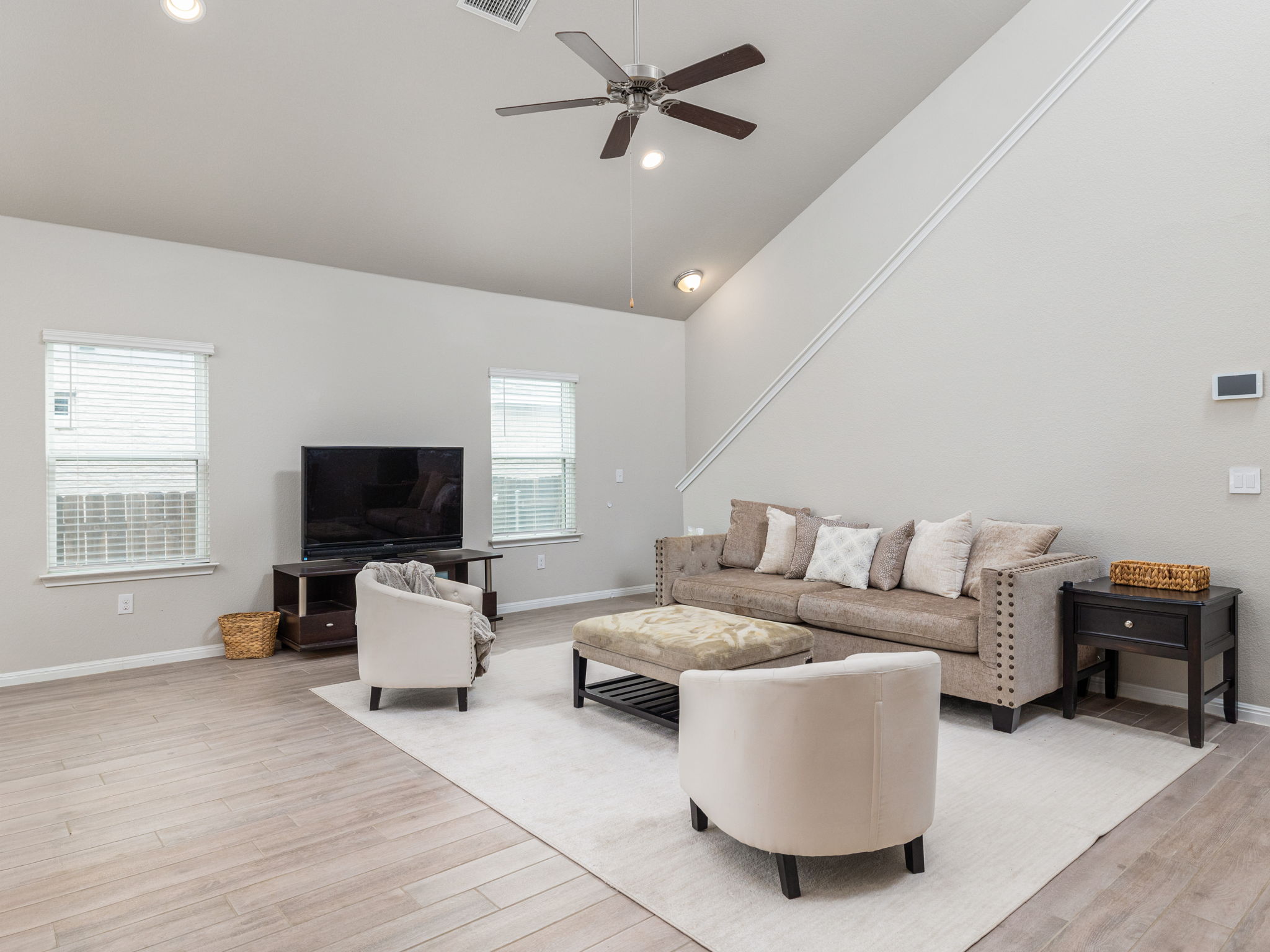 2328 Singletree Bend Georgetown, TX 78628 - Photo 11 of 30 a living room with furniture and a flat screen tv