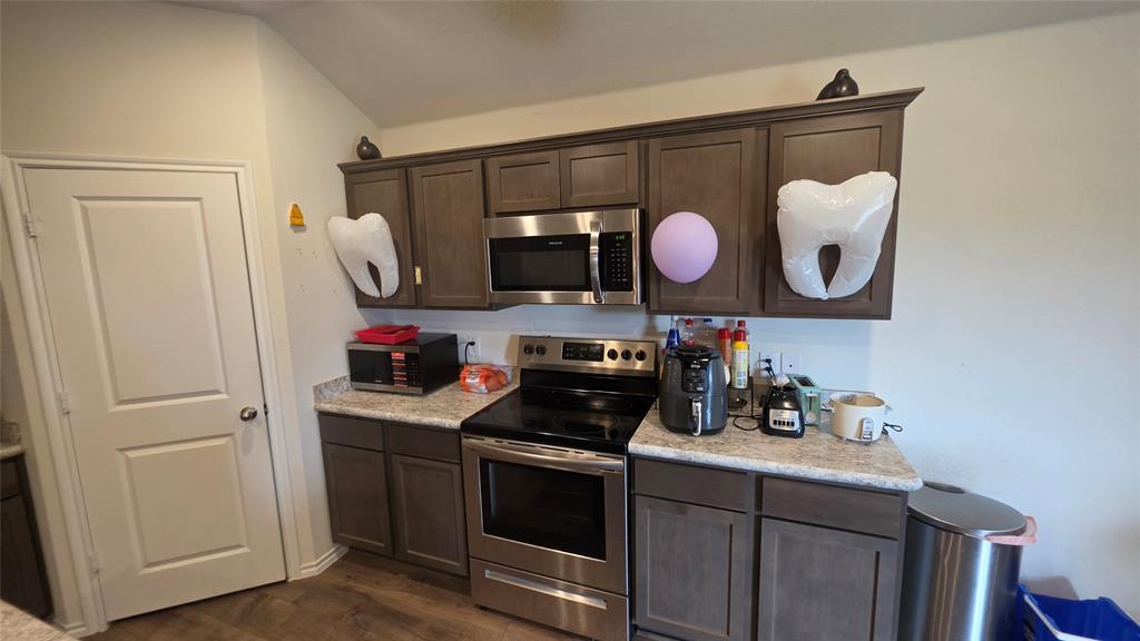 409 Samuel Street Denton, TX 76207 - Photo 22 of 40 a kitchen with a sink and a stove top oven