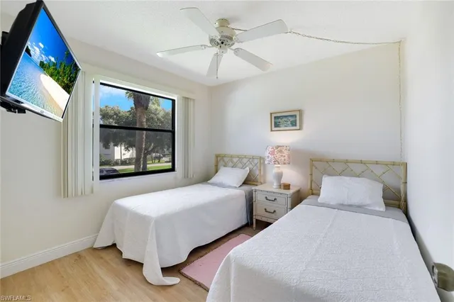 a bedroom with two beds and painting on the wall