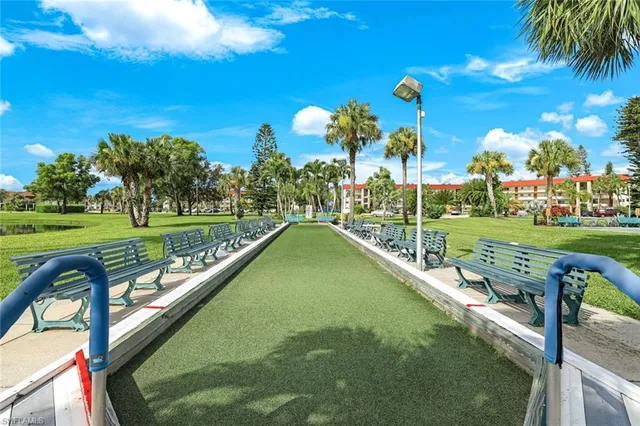 a view of a swimming pool and outdoor seating