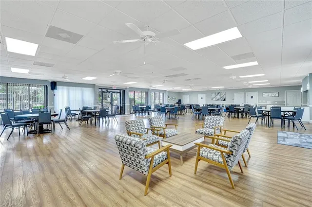 a living room with lots of furniture wooden floor and a table