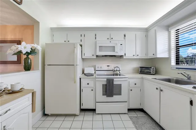 a kitchen with cabinets stainless steel appliances and a sink
