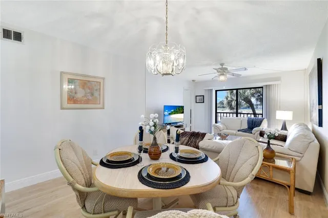 a view of a dining room with furniture wooden floor and chandelier